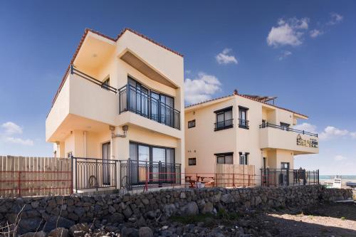 a house on the beach with a stone wall at Geumdanyoung Pension in Jeju