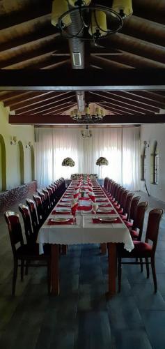 a large long table with chairs in a large room at Hotel Rozafa in Dobrosin