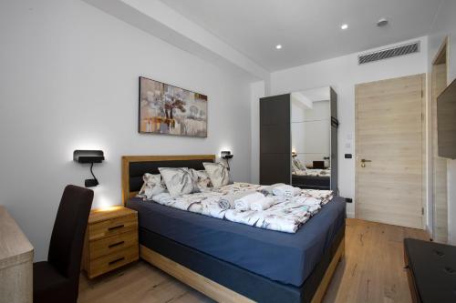 a bedroom with a bed and a desk and a mirror at Villa Rita Pool & Spa in Mascalucia
