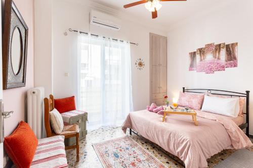 a bedroom with a bed with a table on it at Sofi's Flat in the city center, 5min to the sea in Kalamata