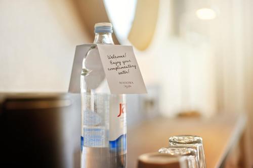 a bottle of water sitting on a counter with a sign on it at Maistra City Vibes Hotel International in Zagreb