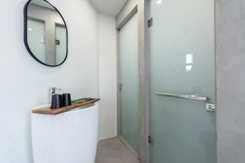 a bathroom with a mirror and a shower at Yu Tainan BnB in Tainan