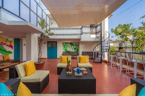 a patio with chairs and tables on a balcony at Zostel Bangalore (Koramangala) in Bangalore