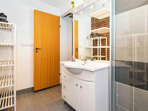 a bathroom with a sink and a glass shower at Holiday home Sydals XCIV in Skovmose