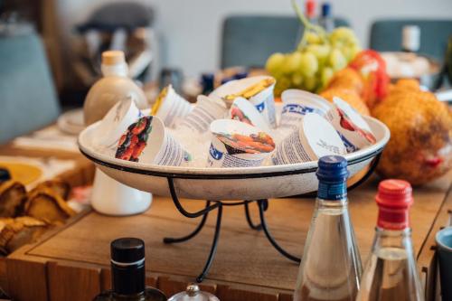 a bowl of food sitting on a table with bottles at Al Pescatore - B&B in Bari