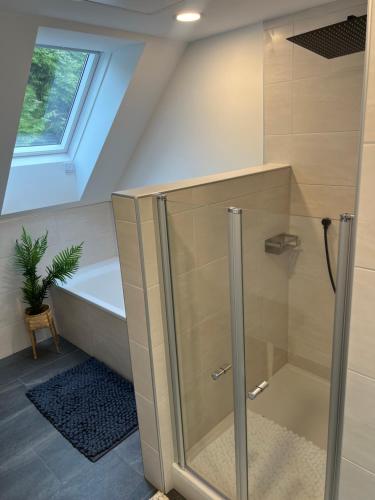 a bathroom with a shower and a bath tub at Waldheimatblick in Sankt Kathrein am Hauenstein