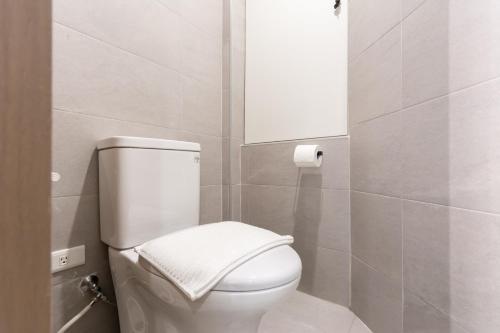 a bathroom with a white toilet and a mirror at Yu Tainan BnB in Tainan