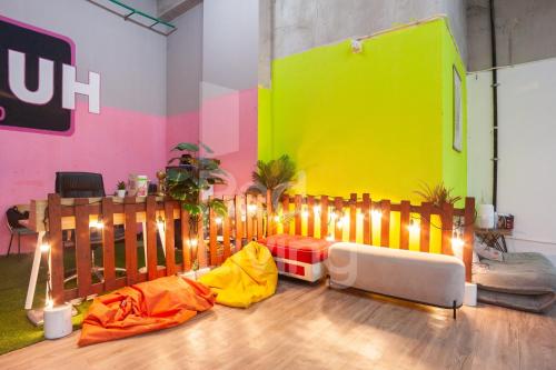 a room with a fence and a colorful wall at RedLiving Apartemen Patra Land Urbano - Iconic Room Tower Mid-West in Bulanbulan