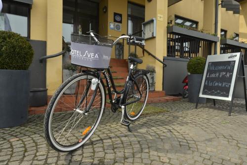 a bike is parked in front of a building at Hotel Svea, BW Signature Collection in Simrishamn