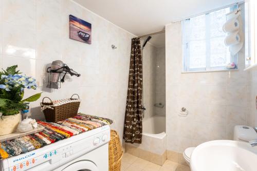 a bathroom with a sink and a toilet and a shower at Sofi's Flat in the city center, 5min to the sea in Kalamata
