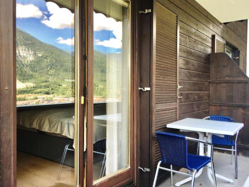 a room with a table and chairs and a window at Fewo Isabella in Mittenwald