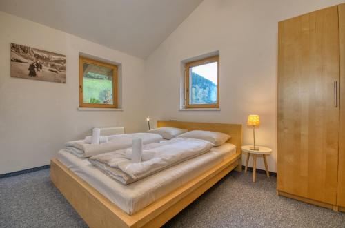 a bedroom with a large bed and a window at Haus Kemp in Zell am See