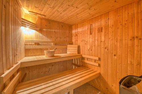 a wooden sauna with a bench in it at Haus Kemp in Zell am See