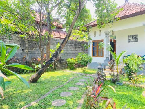 a garden in front of a house at Suris bungalows in Pabean Buleleng