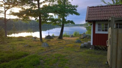 a house with a view of a lake at Långasjönäs Camping & Stugby in Karlshamn