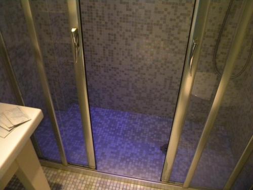 a shower with a glass door in a bathroom at HOTEL GENOVA in Scalea