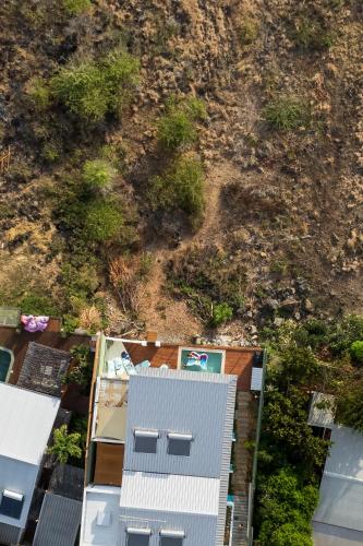an overhead view of a building and a hill at Le Moma by the ocean in Trois Bassins