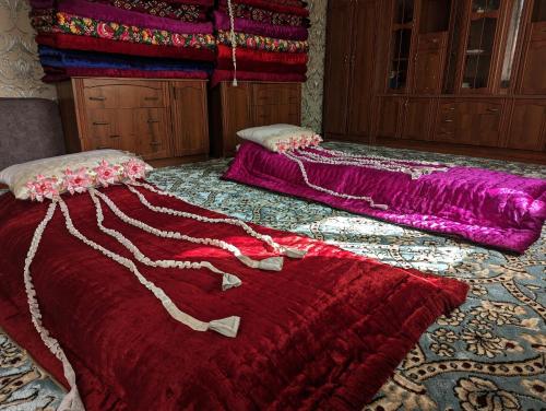 two beds sitting on the floor in a room at Guest house Muslim 