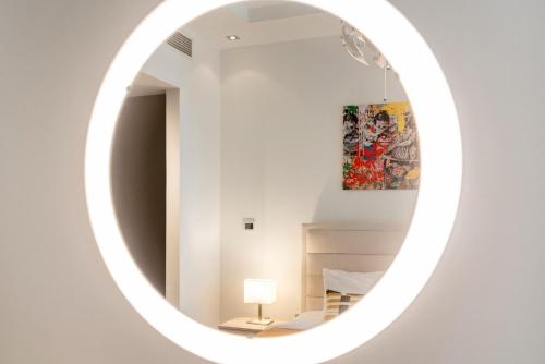 a white mirror in a white room with a lamp at Elegant 1 BDR apt very close to JBR Beach & Marina Walk I Skyview Tower in Dubai