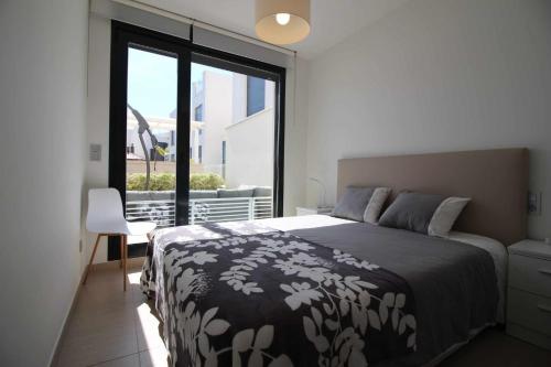 a bedroom with a bed and a large window at Villa Tindra in Torrevieja