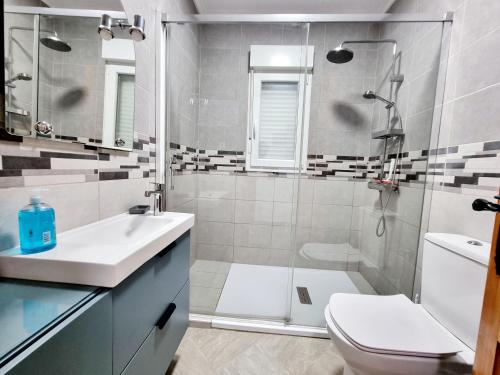 a bathroom with a shower and a sink and a toilet at Charming Villa With Own Pool Urb La Siesta in La Mata