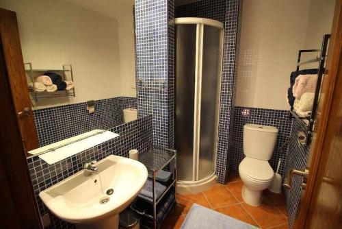 a bathroom with a sink and a toilet and a shower at Punta Marina Green Paradise in Torrevieja