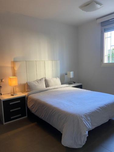 a bedroom with a large bed with a blue comforter at la mata aqua nature in La Mata