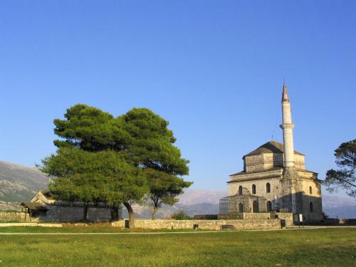 an old church with a tower and a tree at Its Kale Boutique Hotel in Ioannina