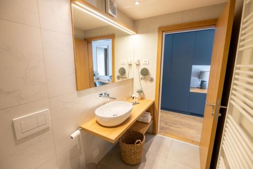 a bathroom with a sink and a mirror at Penzion Šterk in Most na Soči