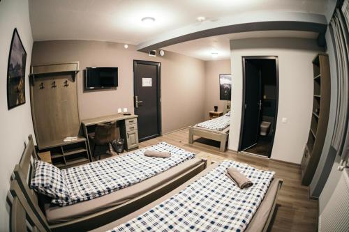 a room with two beds and a mirror at Ride More Activity Center in Miercurea-Ciuc