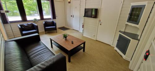 a living room with a couch and a coffee table at Långasjönäs Camping & Stugby in Karlshamn