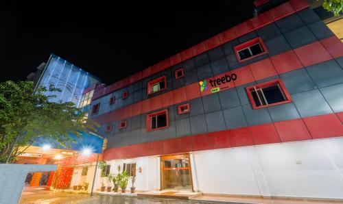 a red and white building with the words hotel at Treebo Trend NGH Transit in Chennai