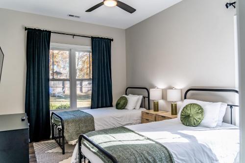a bedroom with two beds and a window at The Downtown Ace in Southern Pines