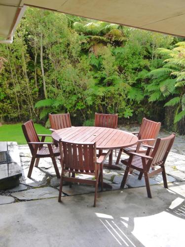 a wooden table with four chairs around it at Central & Relaxing in Franz Josef