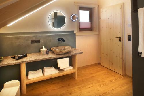 a bathroom with a sink and a mirror at "Allgäu-Herzl" Alpenchalet für Zwei in Rückholz