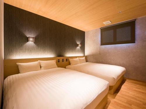 two beds sitting next to each other in a room at Rakuten STAY VILLA Nasu in Nasu