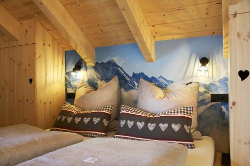 a bedroom with a mountain mural on the wall at "Allgäu-Herzl" Alpenchalet für Zwei in Rückholz