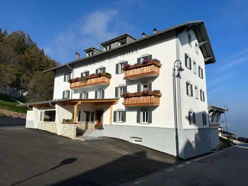 a white building with balconies on the side of it at PANORAMA SportHOTEL in Folgaria