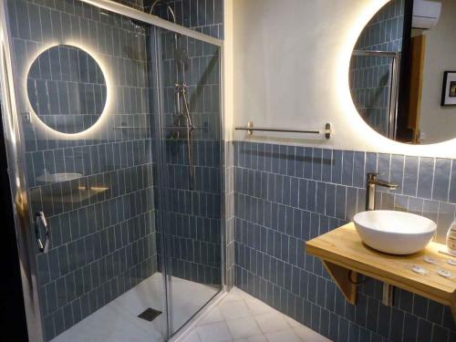 a bathroom with a sink and a glass shower at OLBLANC Plaza de España by Batuecas in Madrid