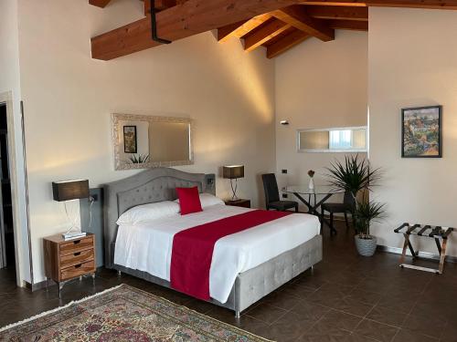 a bedroom with a bed and a table and chairs at Vi Ja Villa Janas Cagliari Resort in Cagliari