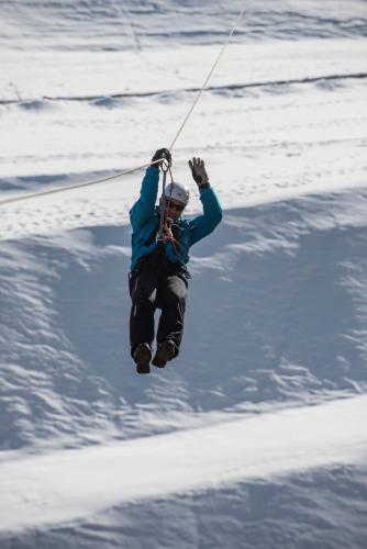 a person being pulled on a rope in the snow at Gaya Residences in Shahdag