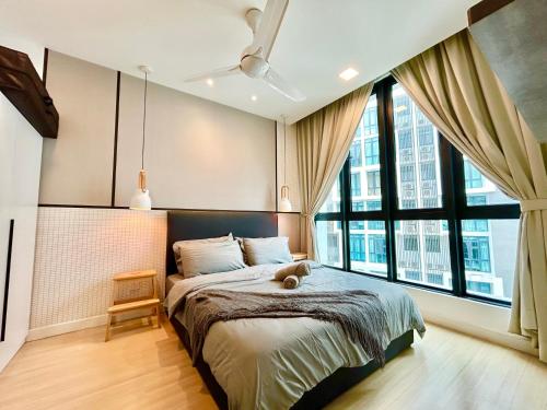 a bedroom with a bed with a teddy bear on it at Comfort Place 1-8 Pax 3Q beds Ara Damansara Center in Petaling Jaya