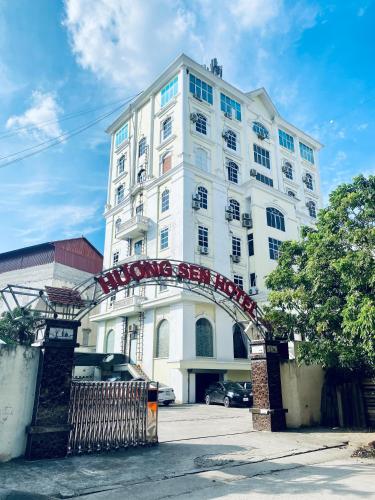 a white building with an arch in front of it at Hương Sen Hotel Bac Giang in Bắc Giang