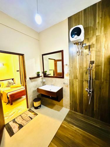 a bathroom with a sink and a mirror at Ella Family House in Ella