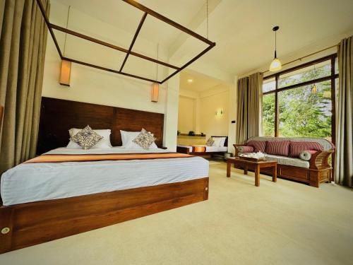 a bedroom with a large bed and a couch at Ella Family House in Ella