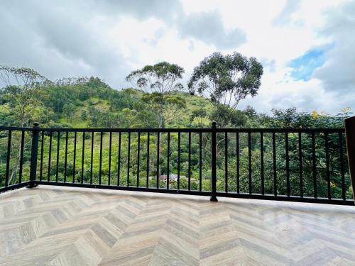 a balcony with a black fence and a view of a mountain at Ella Family House in Ella