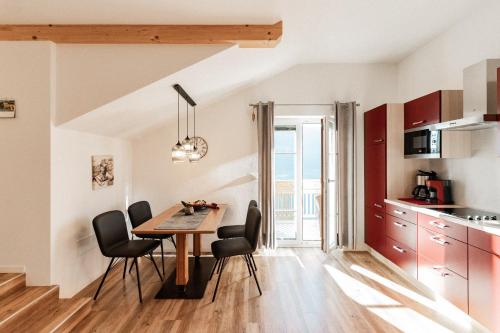 a kitchen and dining room with a table and chairs at Apartment Niederhaushof in Parcines