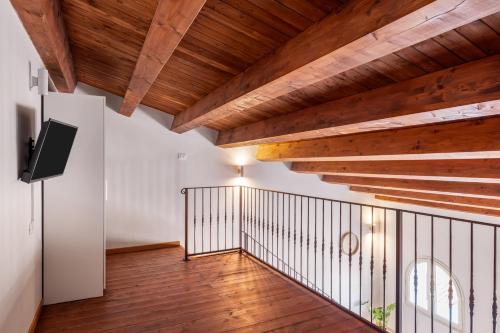 a hallway with wooden ceilings and wooden flooring at Open Sicily Homes - Near the Central Train Station in Palermo