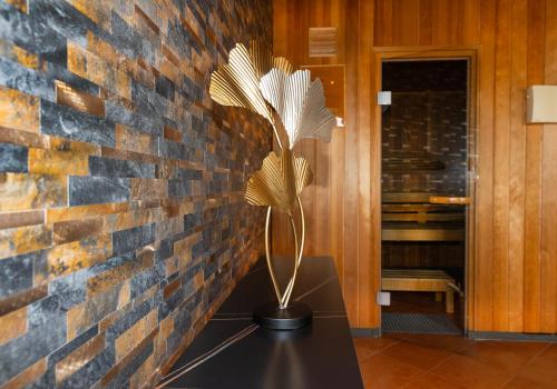 a plant sitting on a table in front of a brick wall at Hotel Carolinenhof in Berlin