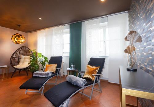 a room with chairs and a table and some windows at Hotel Carolinenhof in Berlin